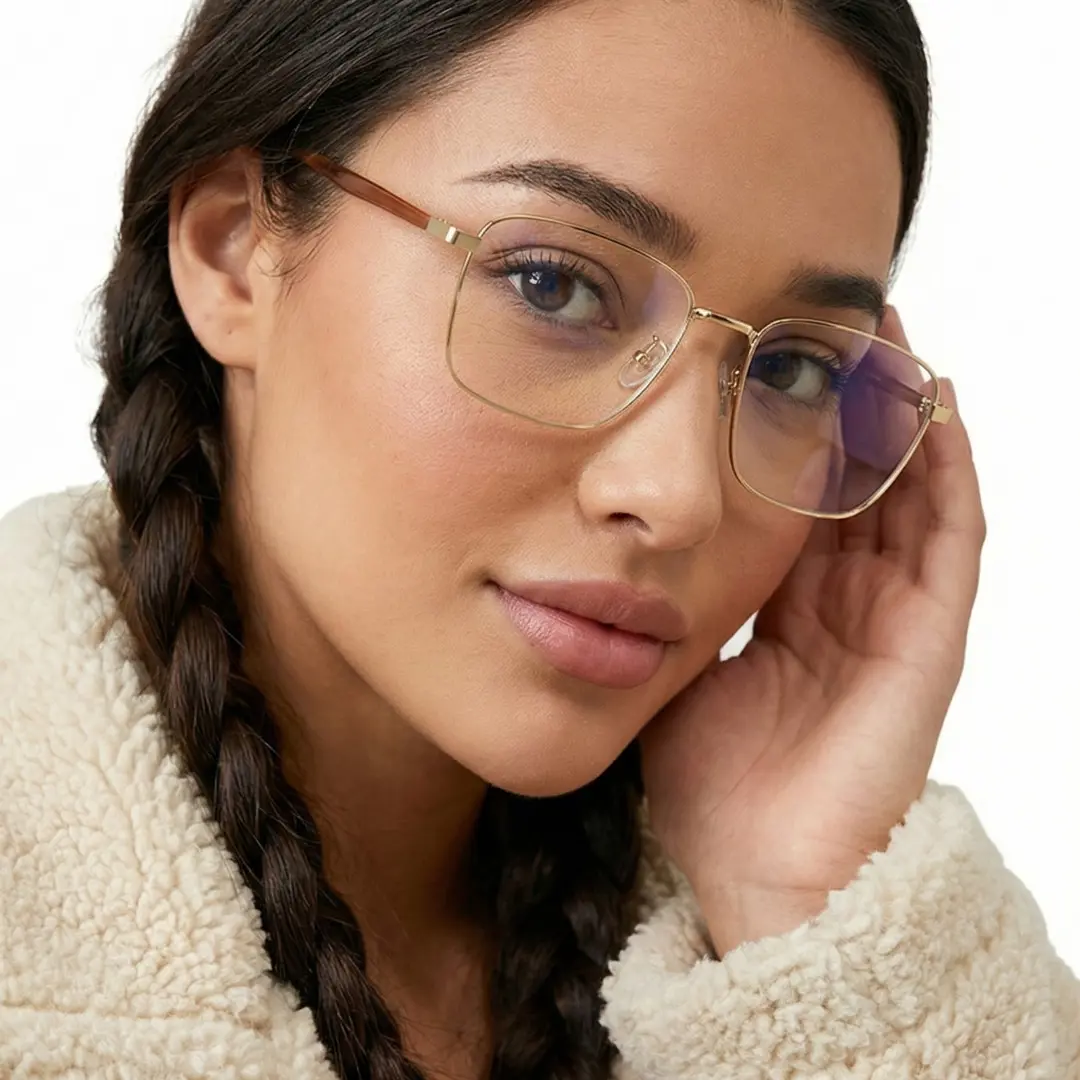 Profile view of female wearing gold rectangle eyeglasses, smiling, EM0242508
