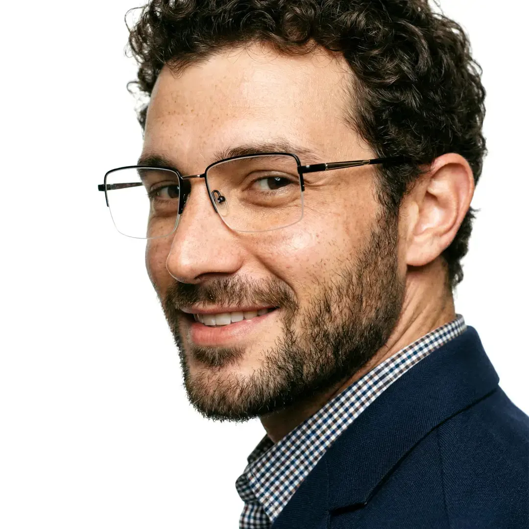Profile view of male wearing black rectangle eyeglasses, smiling, EM0252508