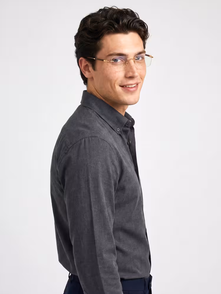 Male model wearing glitter gold rectangle metal rimless eyeglasses against plain white studio background. SPU:EM0402508