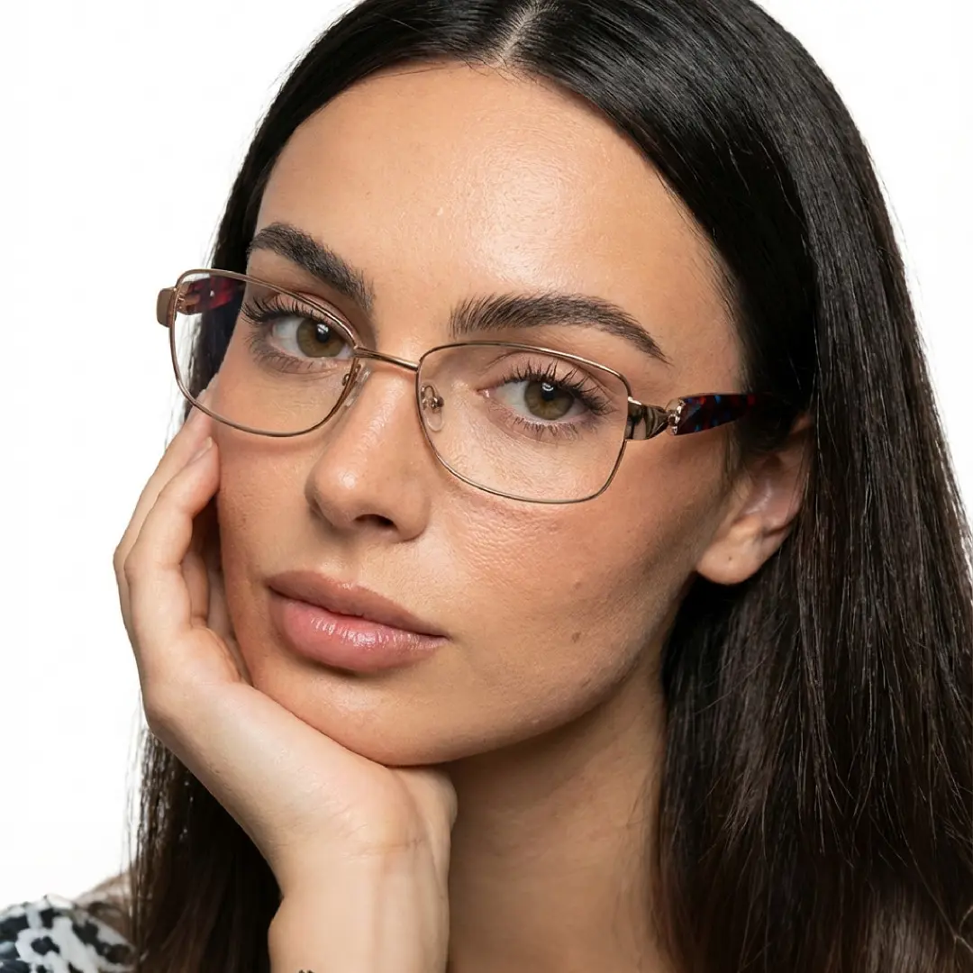 Tilted head view of female wearing brown rectangle eyeglasses, resting chin on hand, neutral expression, EM0482509