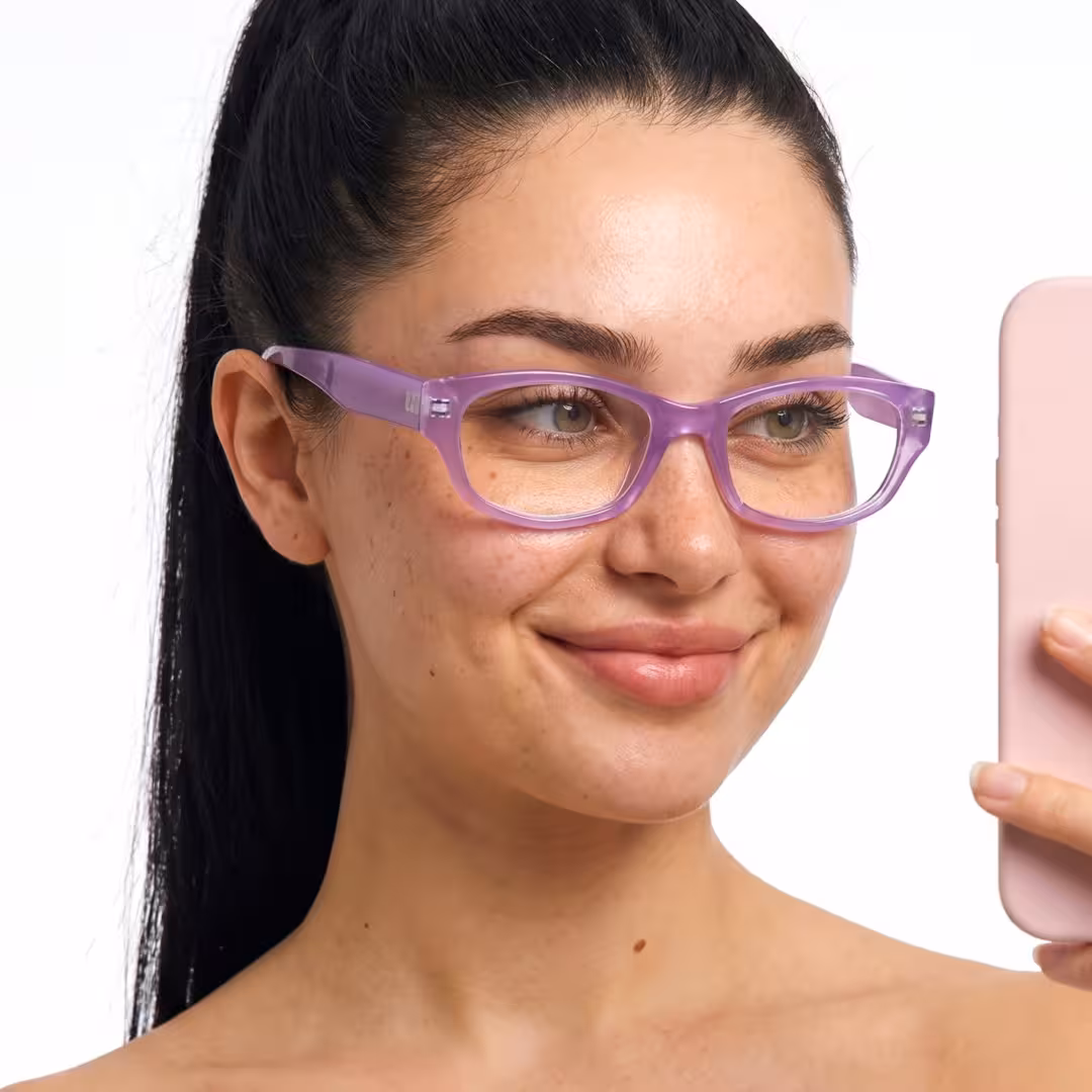 Face close-up view of female wearing purple rectangle eyeglasses, taking a selfie, natural smile, EP0342604
