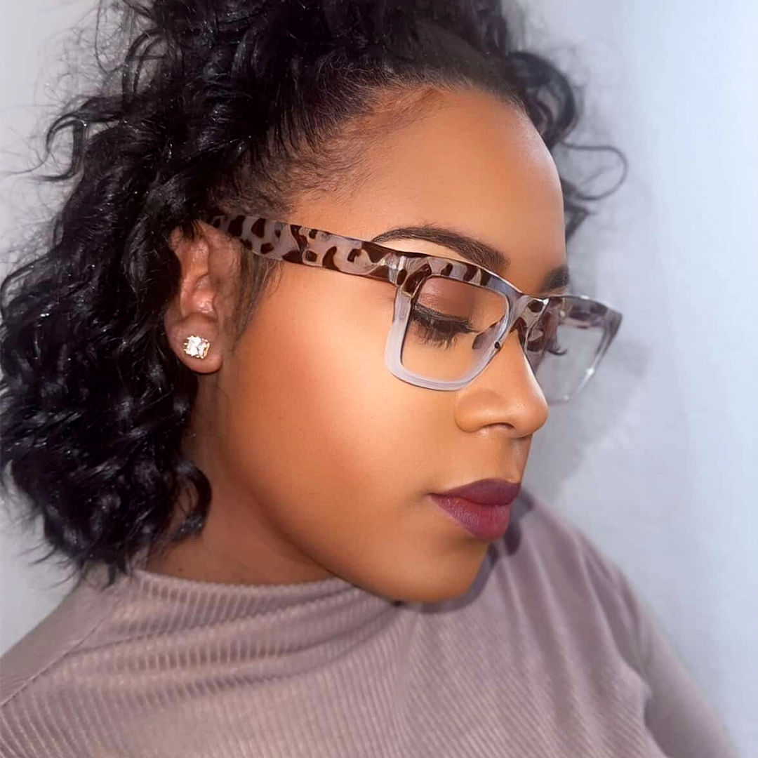 Profile view of female wearing two-tone rectangle eyeglasses, looking downward, neutral expression, EP0432505