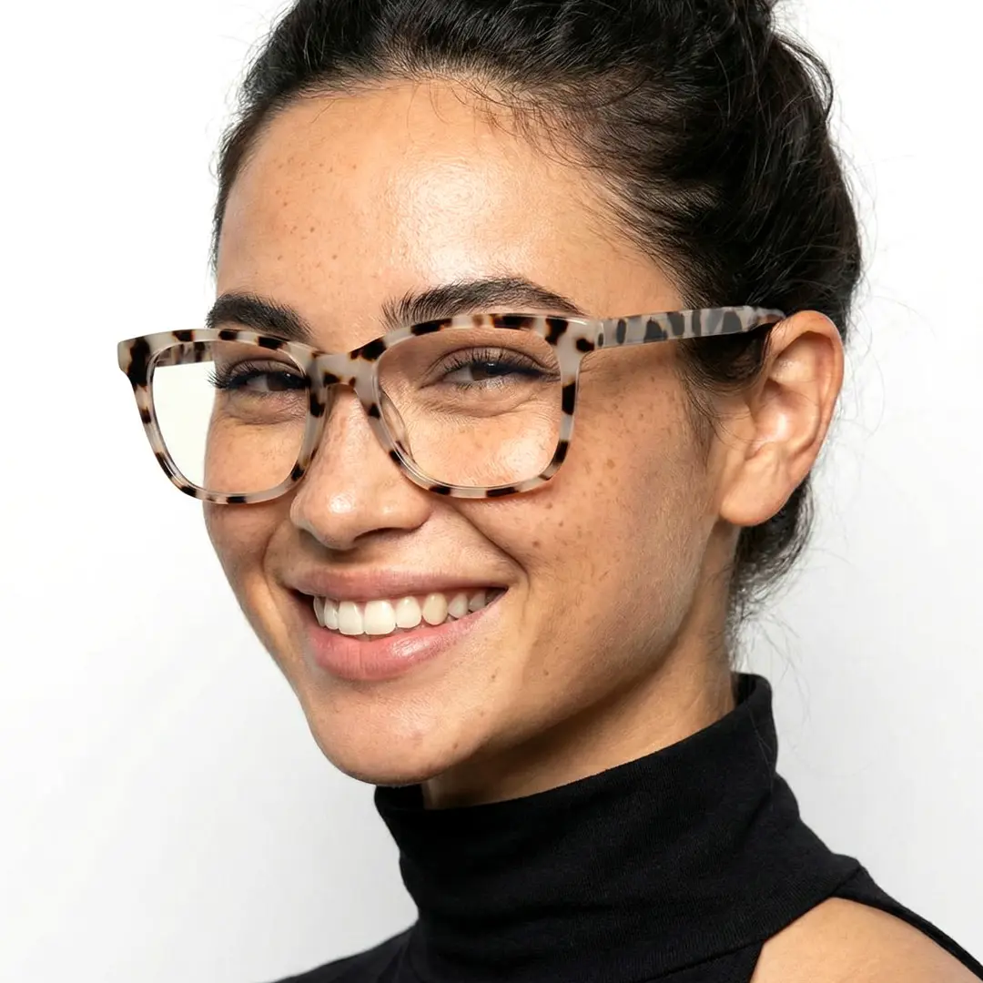 Three-quarter view of female wearing tortoise rectangle eyeglasses, smiling, EP0482505