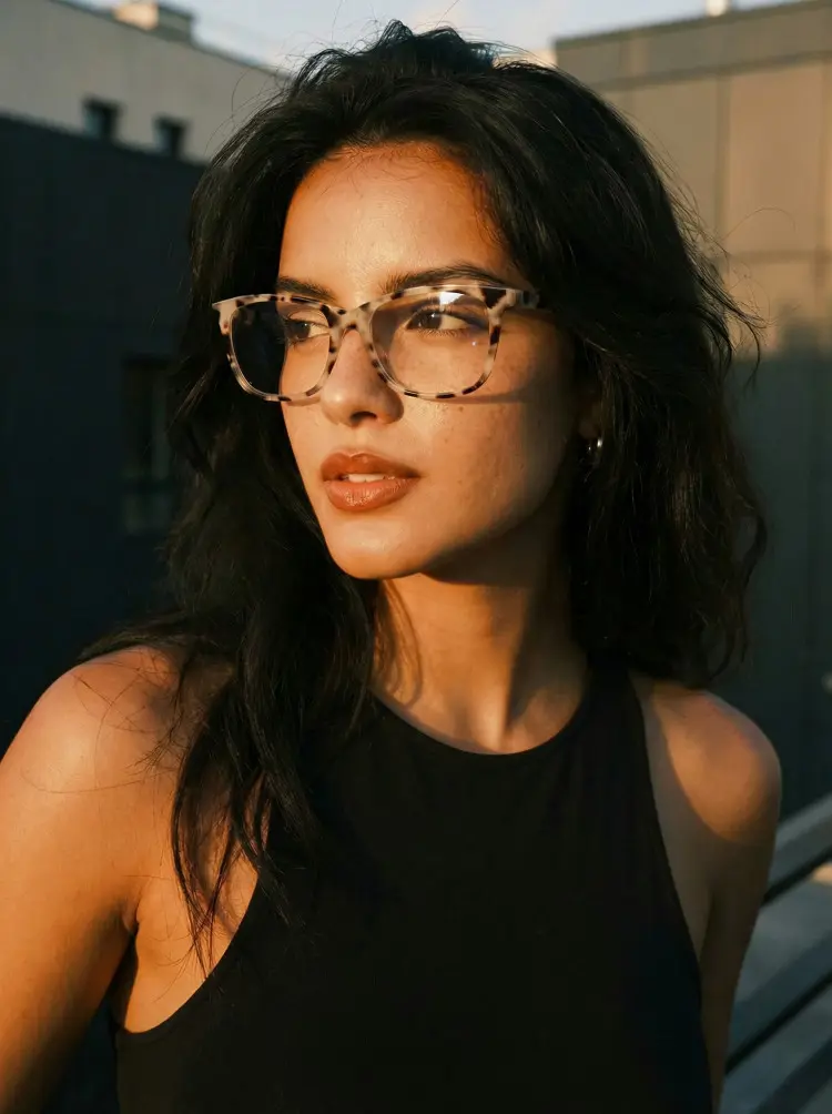 Female model wearing everyday tortoise rectangle pc eyeglasses on a sunlit urban rooftop during golden hour. SPU: EP0482505