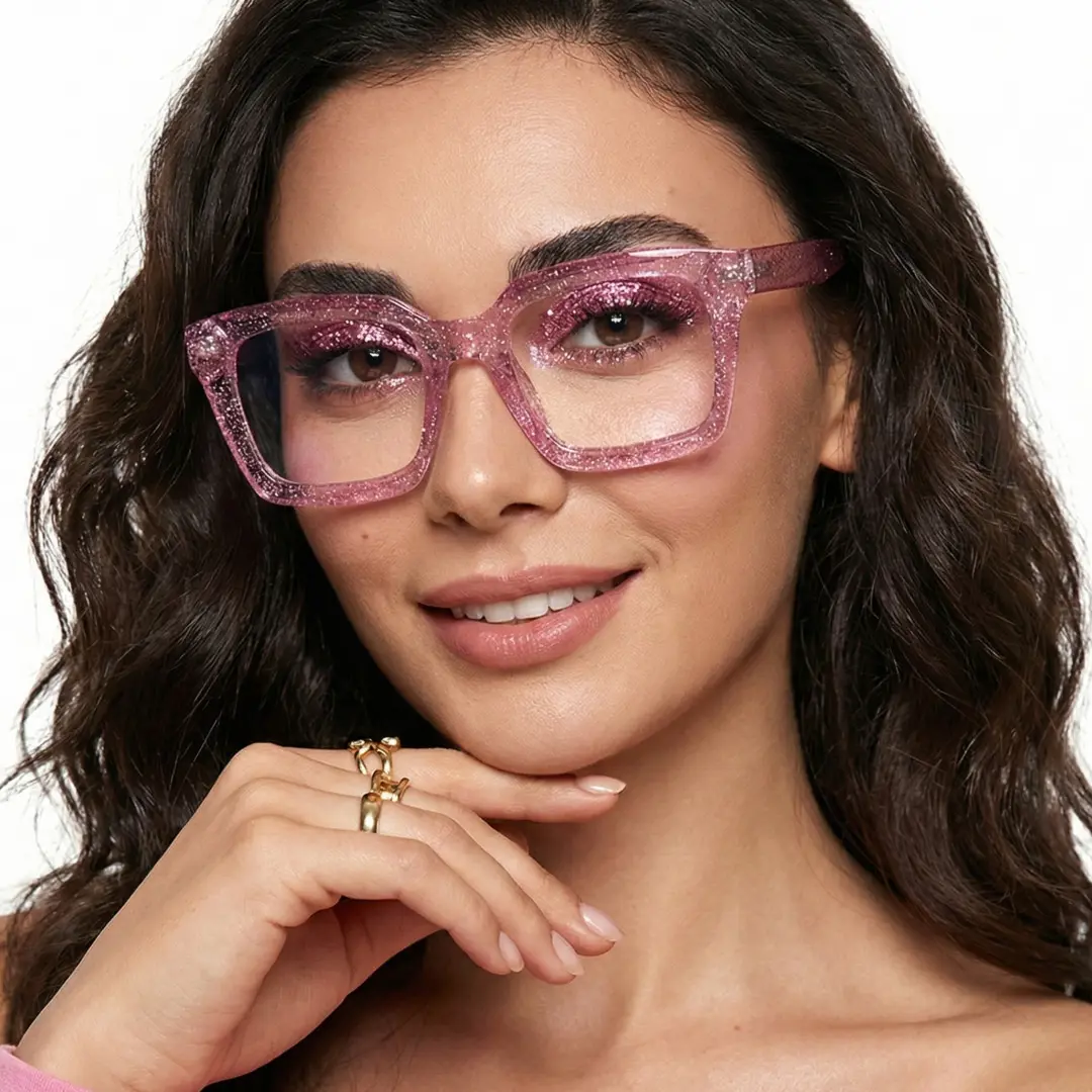 Close-up view of female wearing pink rectangle eyeglasses, hand touching chin, smiling, ER0032504
