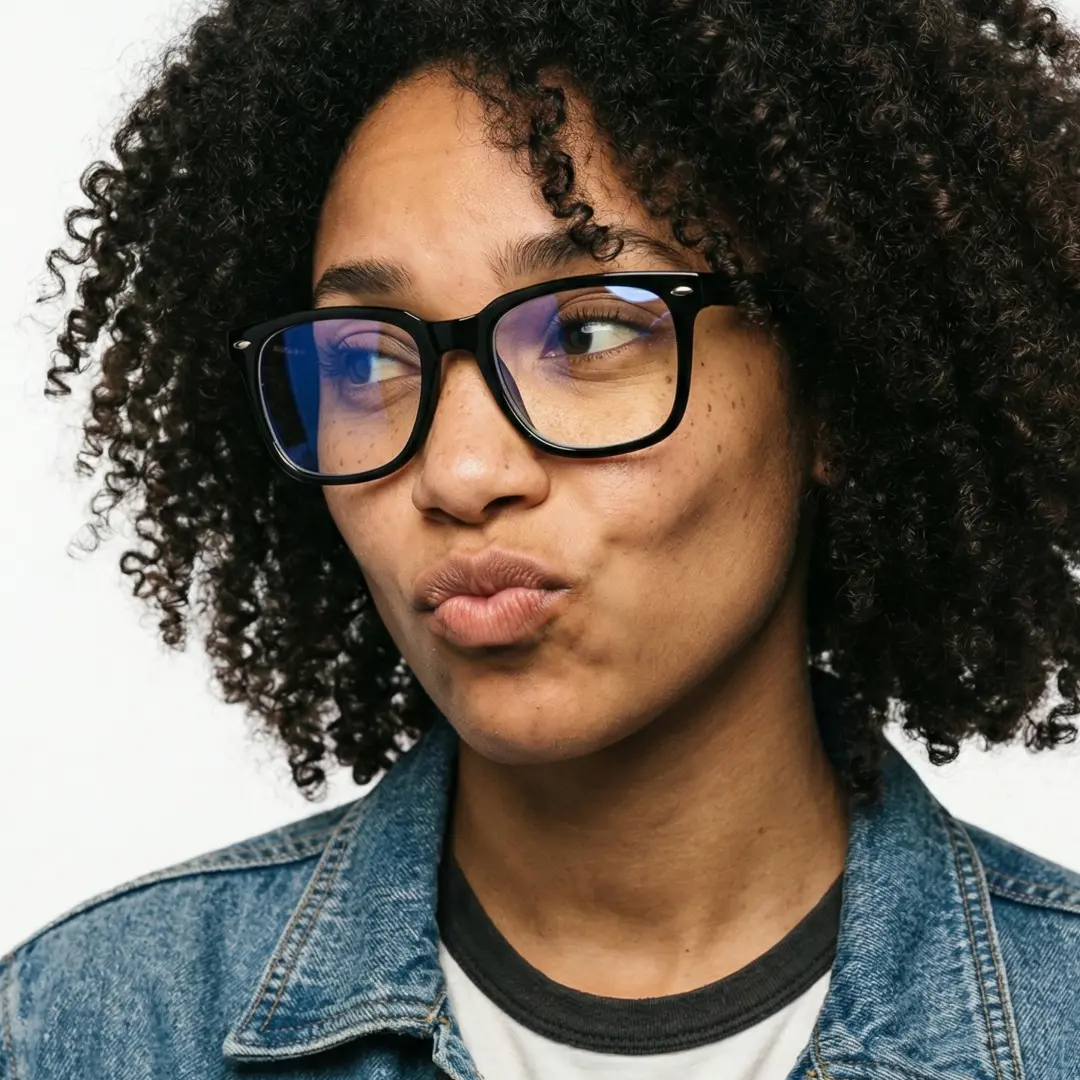 Looking away view of female wearing black rectangle eyeglasses, pouting, relaxed expression, ER0042510