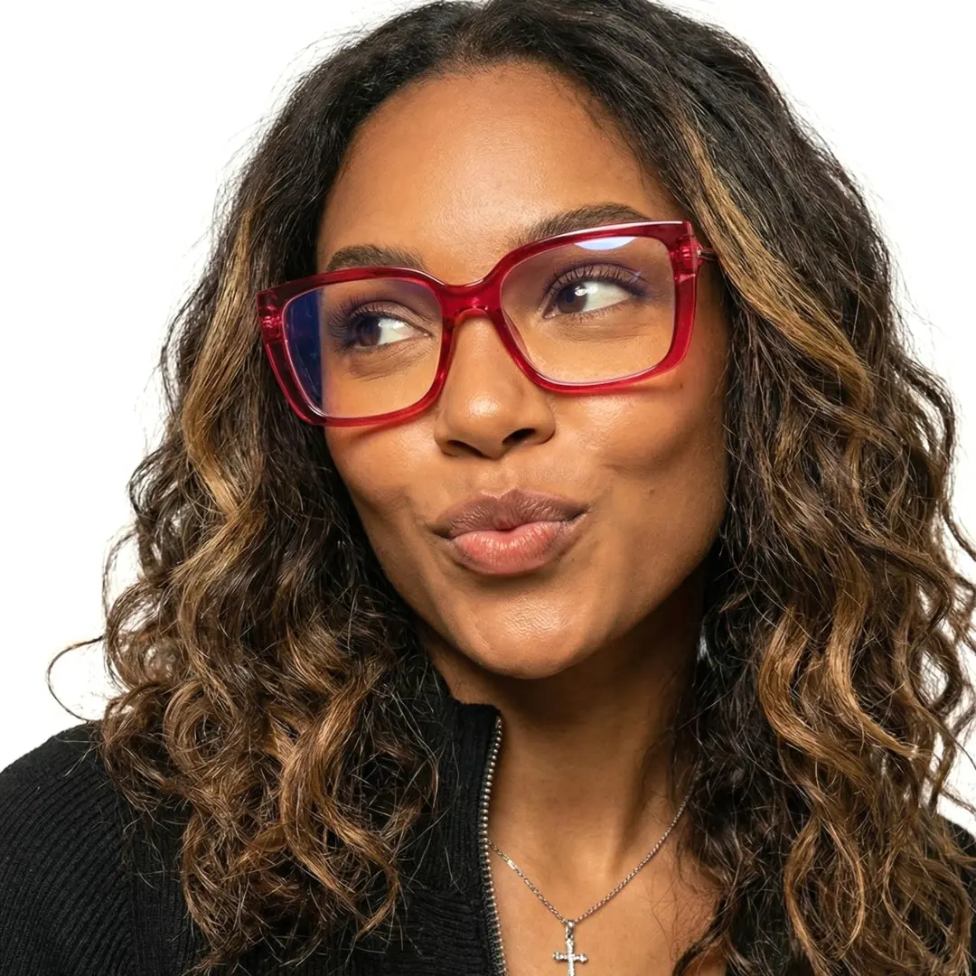 Looking away view of female wearing red rectangle eyeglasses, pouting, relaxed expression, ER0072510