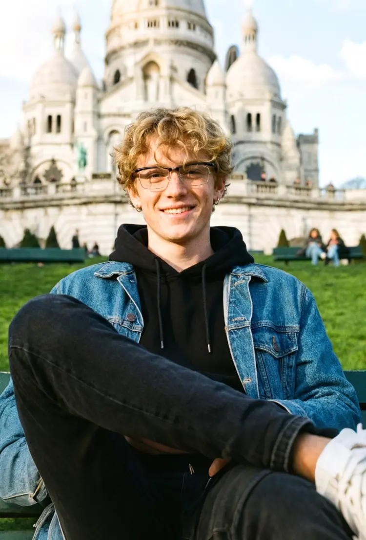 Male model wearing everyday black rectangle tr90 eyeglasses at a scenic city park. SPU: ER0102603