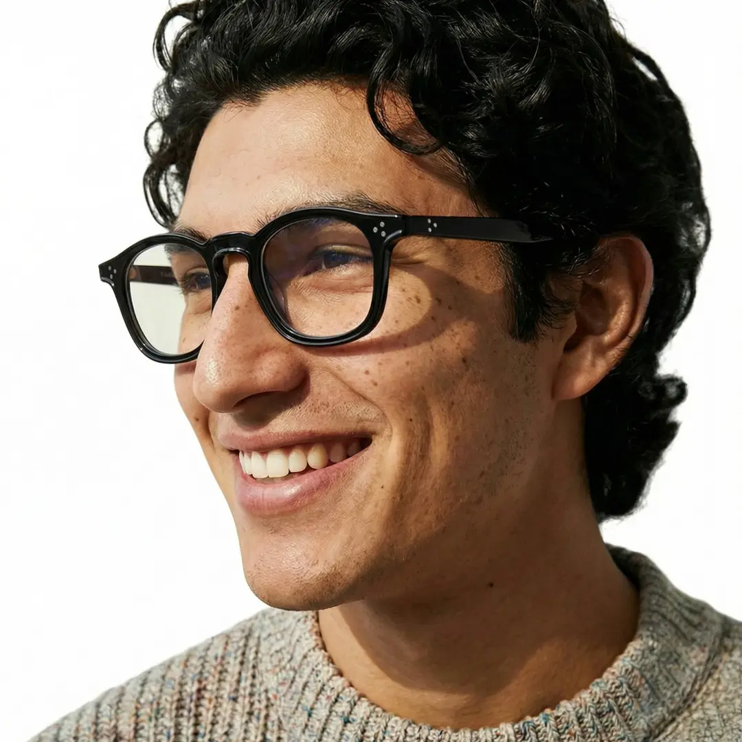 Profile view of male wearing black rectangle eyeglasses, smiling, ER0112412