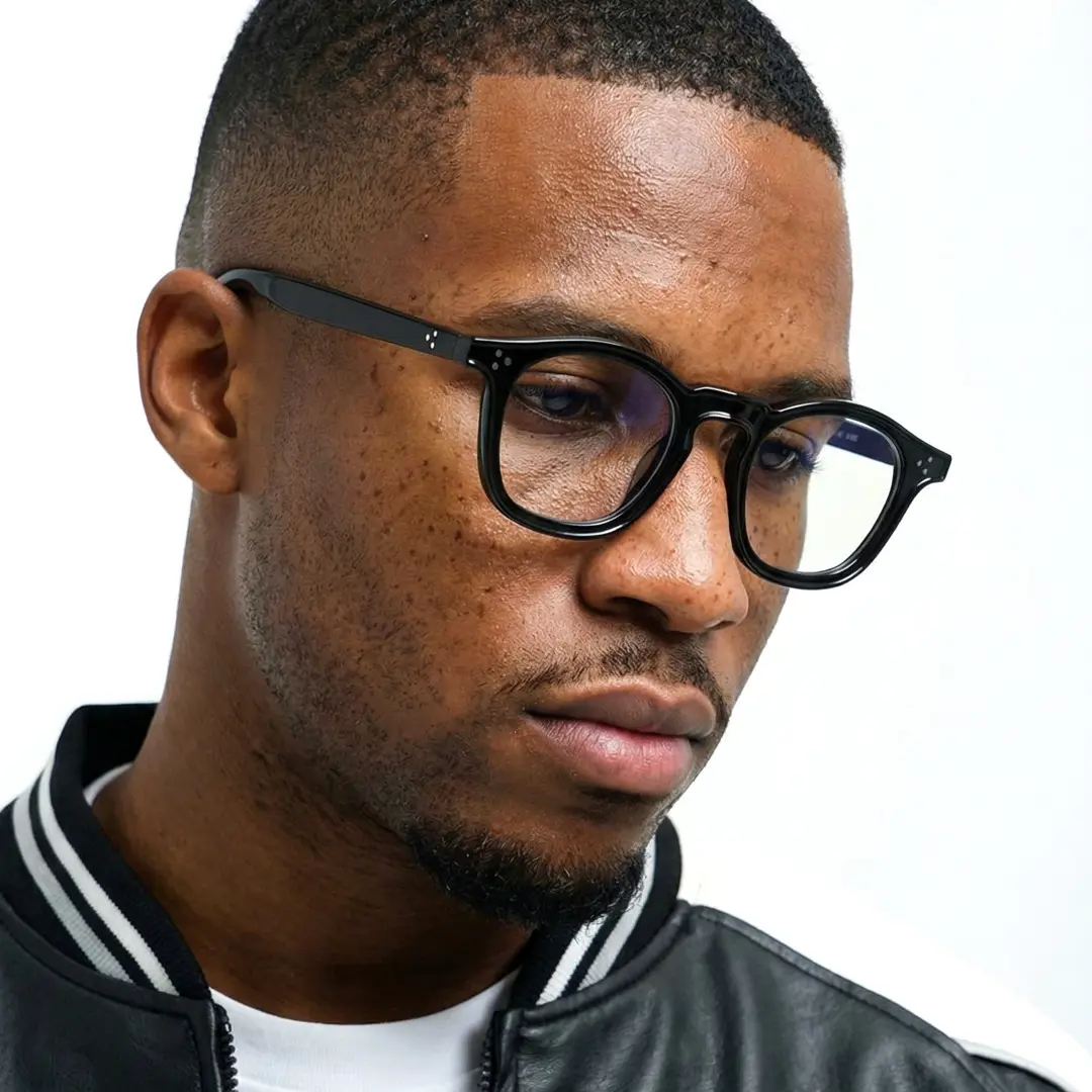 Three-quarter view of male wearing black rectangle eyeglasses, calm expression, ER0112412