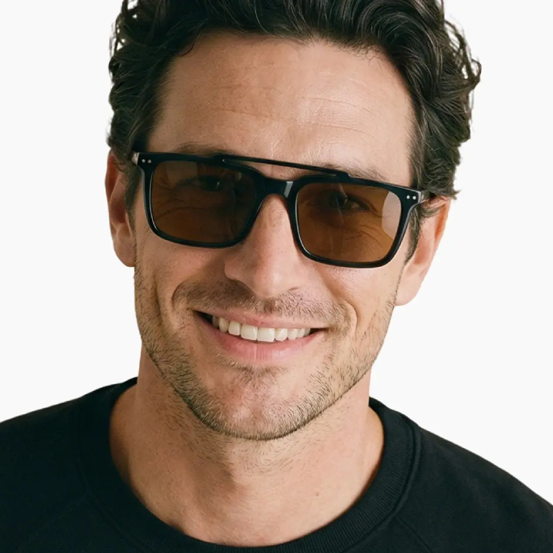 Front view of male wearing black rectangle magnetic clip-on eyeglasses set with interchangeable clip-on lenses, natural smile, ER0142601