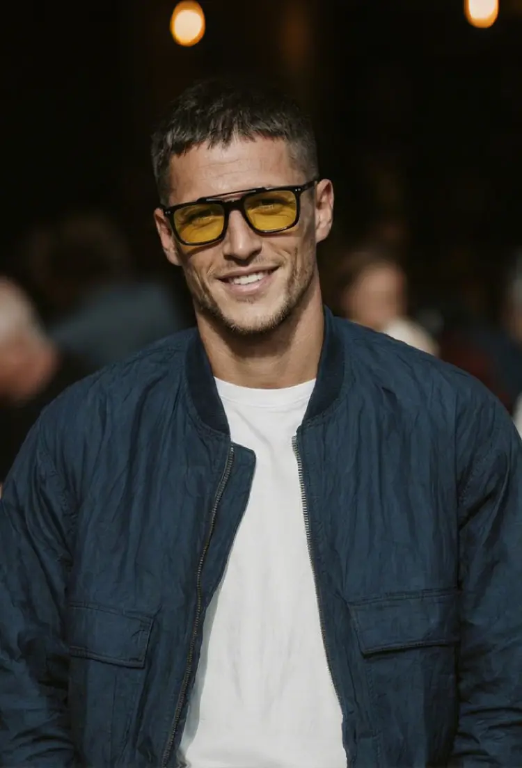 Male model wearing magnetic black rectangle tr90 magnetic clip-on eyeglasses set with interchangeable clip-on lenses smiling in a blue jacket with a dark background. SPU: ER0142601