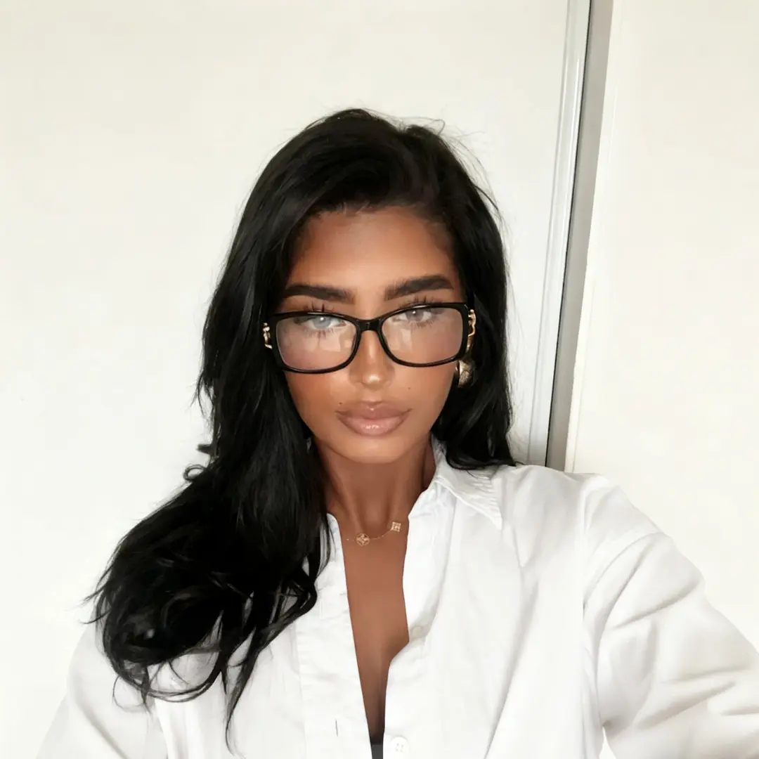 Front view of female wearing vintage black rectangle eyeglasses, taking a selfie, natural expression, ER0172509