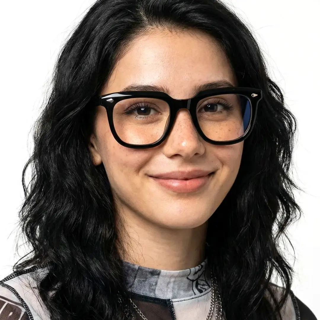 Front view of female wearing black rectangle eyeglasses, soft smile, ER0182412