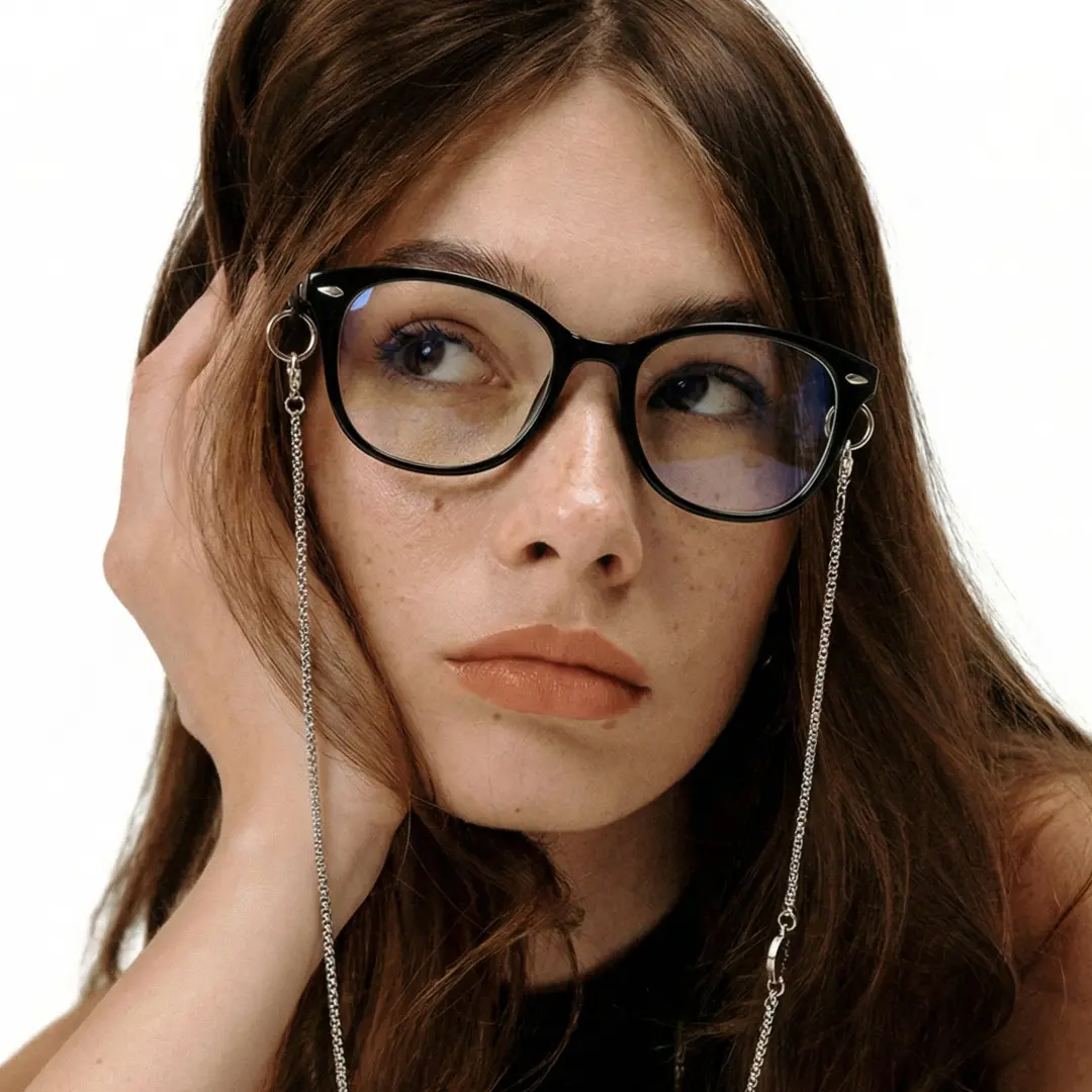 Looking away view of female wearing fashion black rectangle eyeglasses, hand in hair, natural expression, ER0212601
