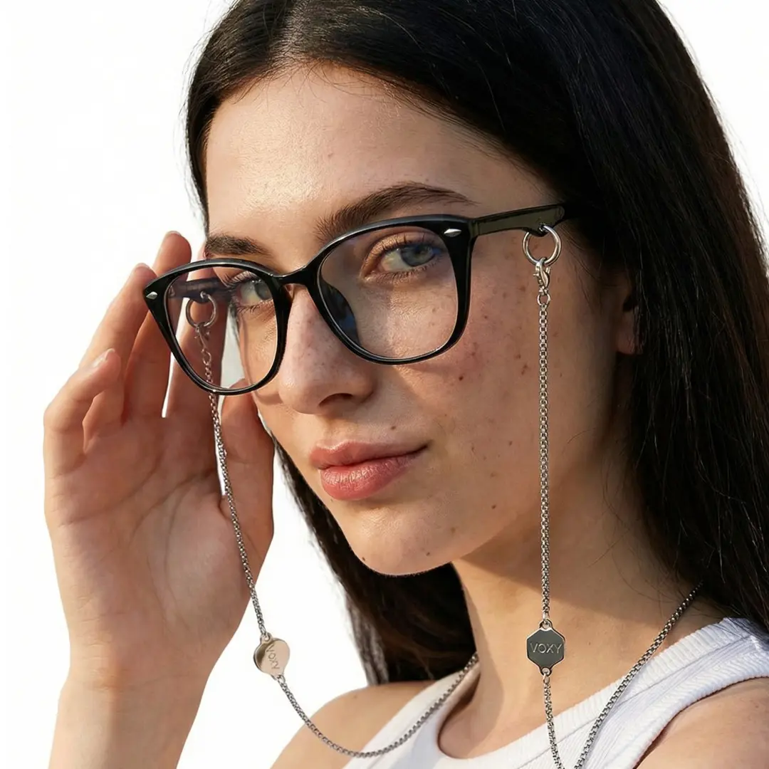 Three-quarter view of female wearing fashion black rectangle eyeglasses, holding glasses, natural expression, ER0212601