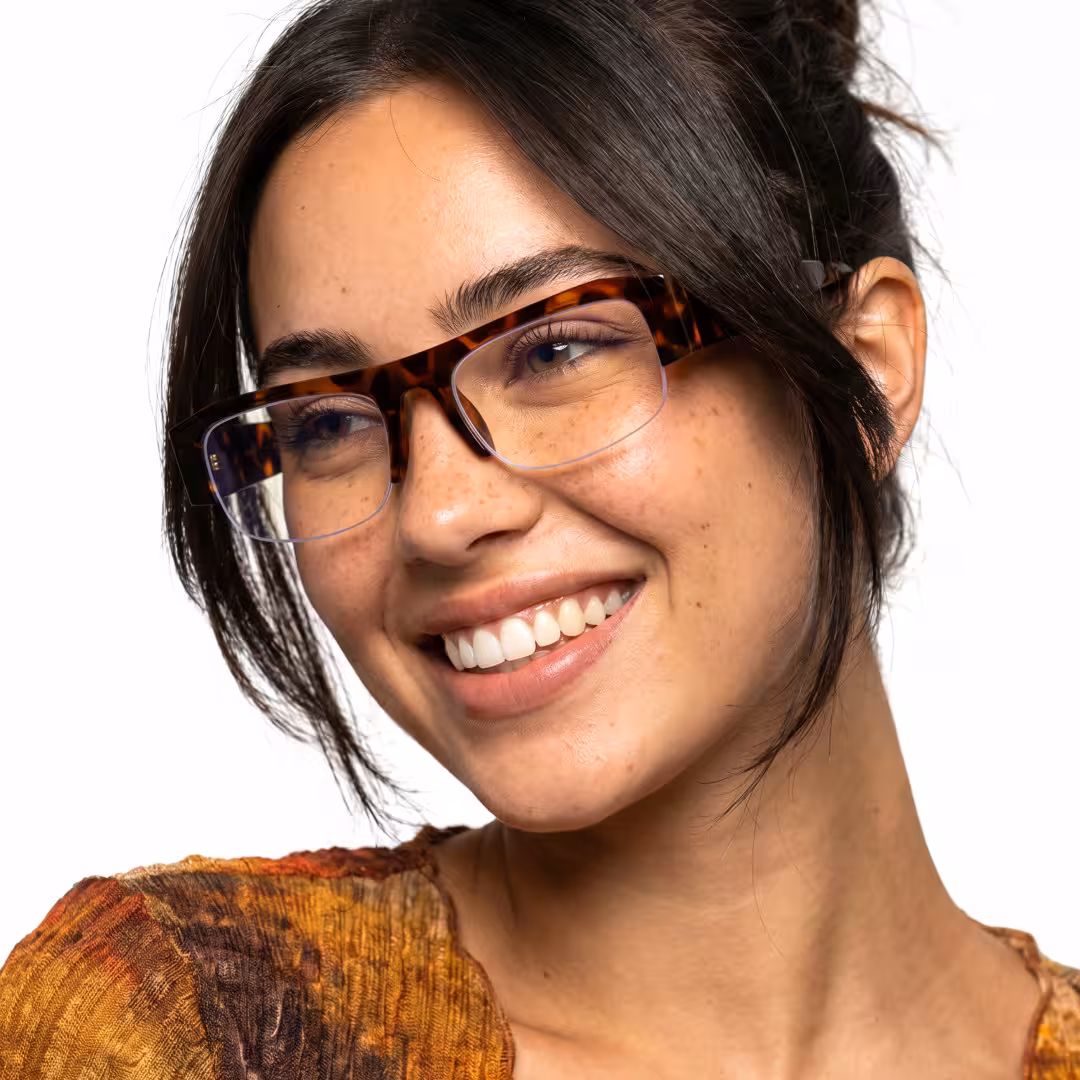 Profile view of female wearing fashion tortoise rectangle eyeglasses, smiling, ER0212604