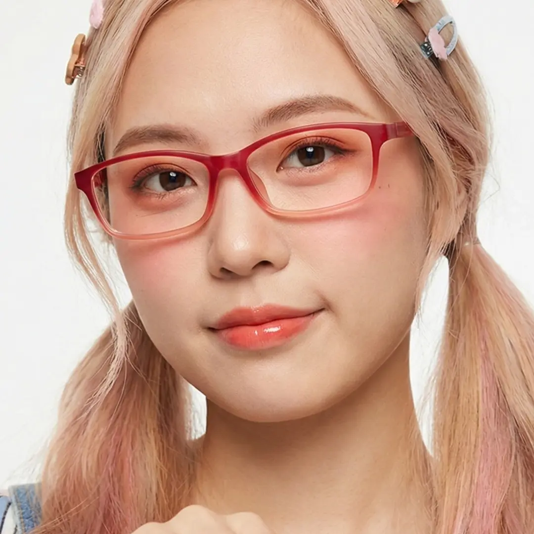 Face close-up view of female wearing red rectangle eyeglasses, soft smile, ER0232411