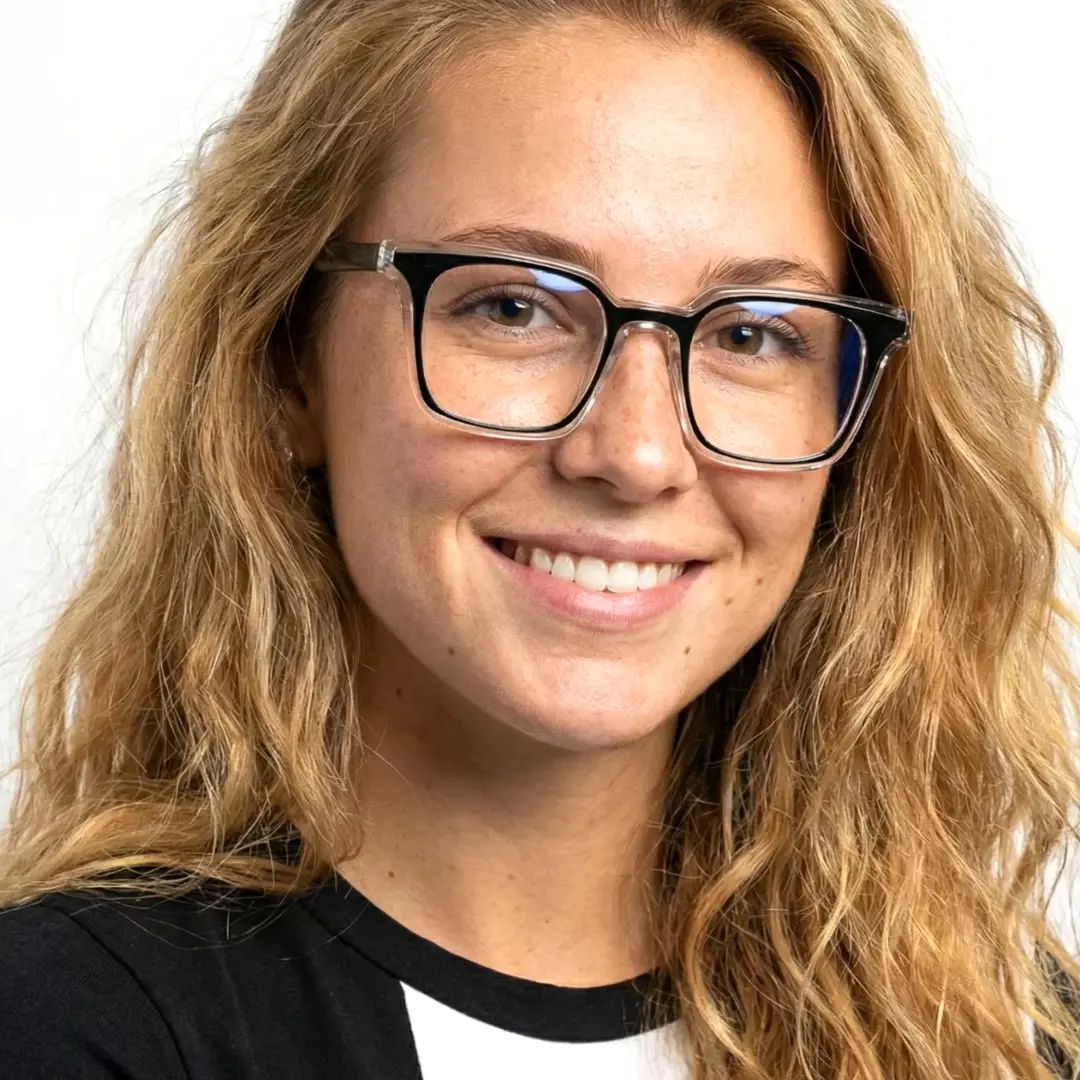 Slightly angled view of female wearing black rectangle eyeglasses, smiling, ER0232508