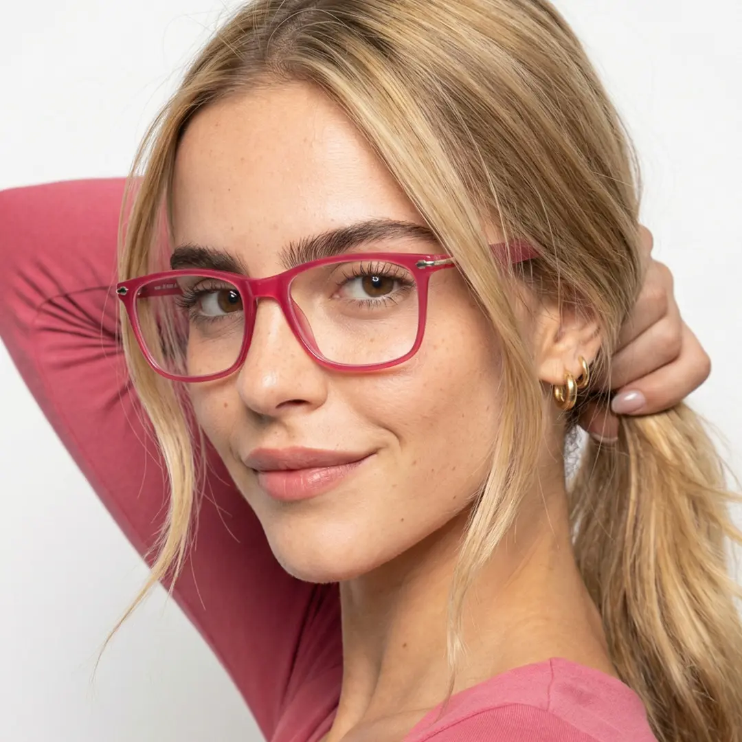 Three-quarter view of female wearing red rectangle eyeglasses, soft smile, ER0272411