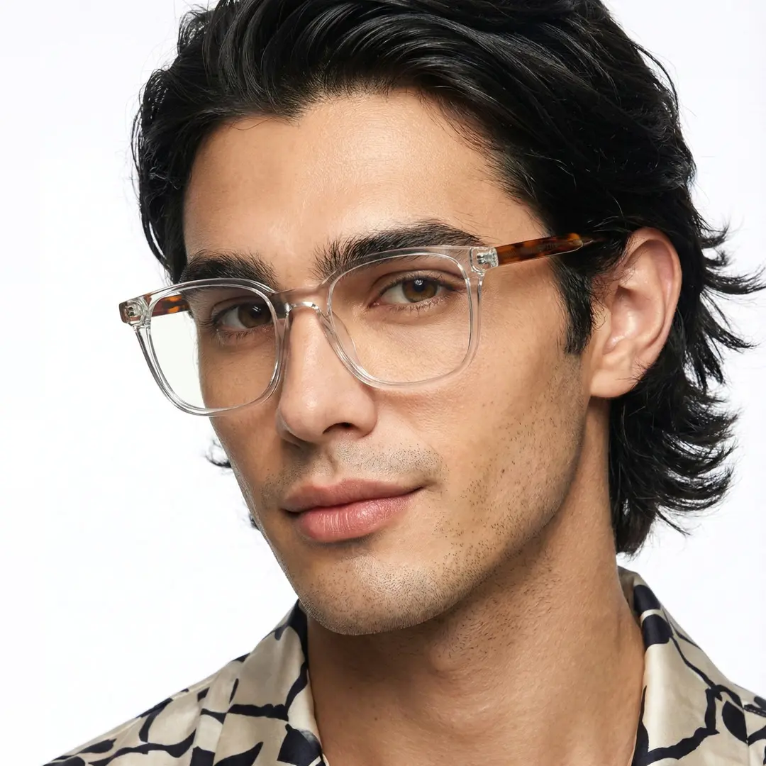 Three-quarter view of male wearing clear rectangle eyeglasses, smiling, ER0462508