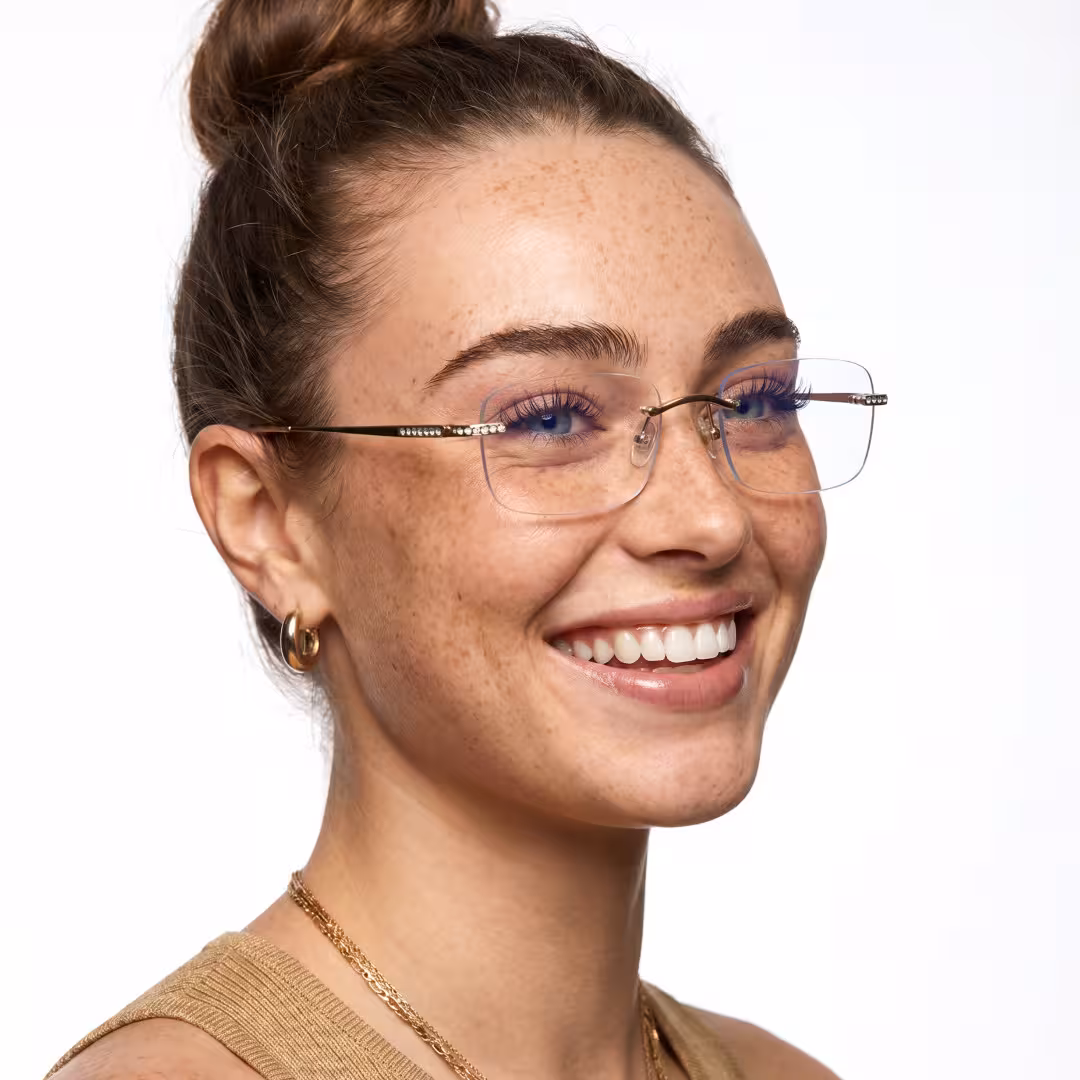 Female wearing gold rectangle titanium eyeglasses, smiling. SPU: ET0022605
