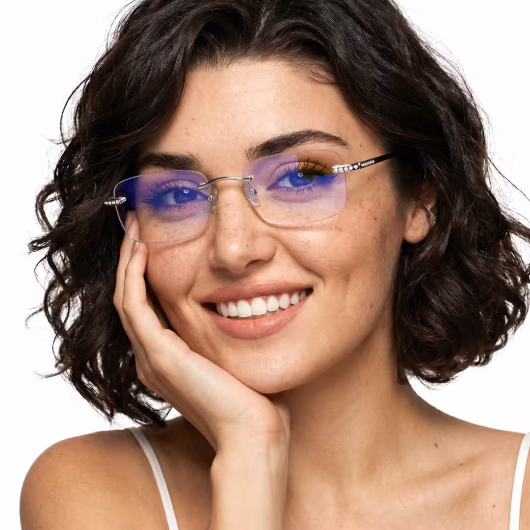 Front view of female wearing silver rectangle eyeglasses, resting chin on hand, smiling, ET0022605