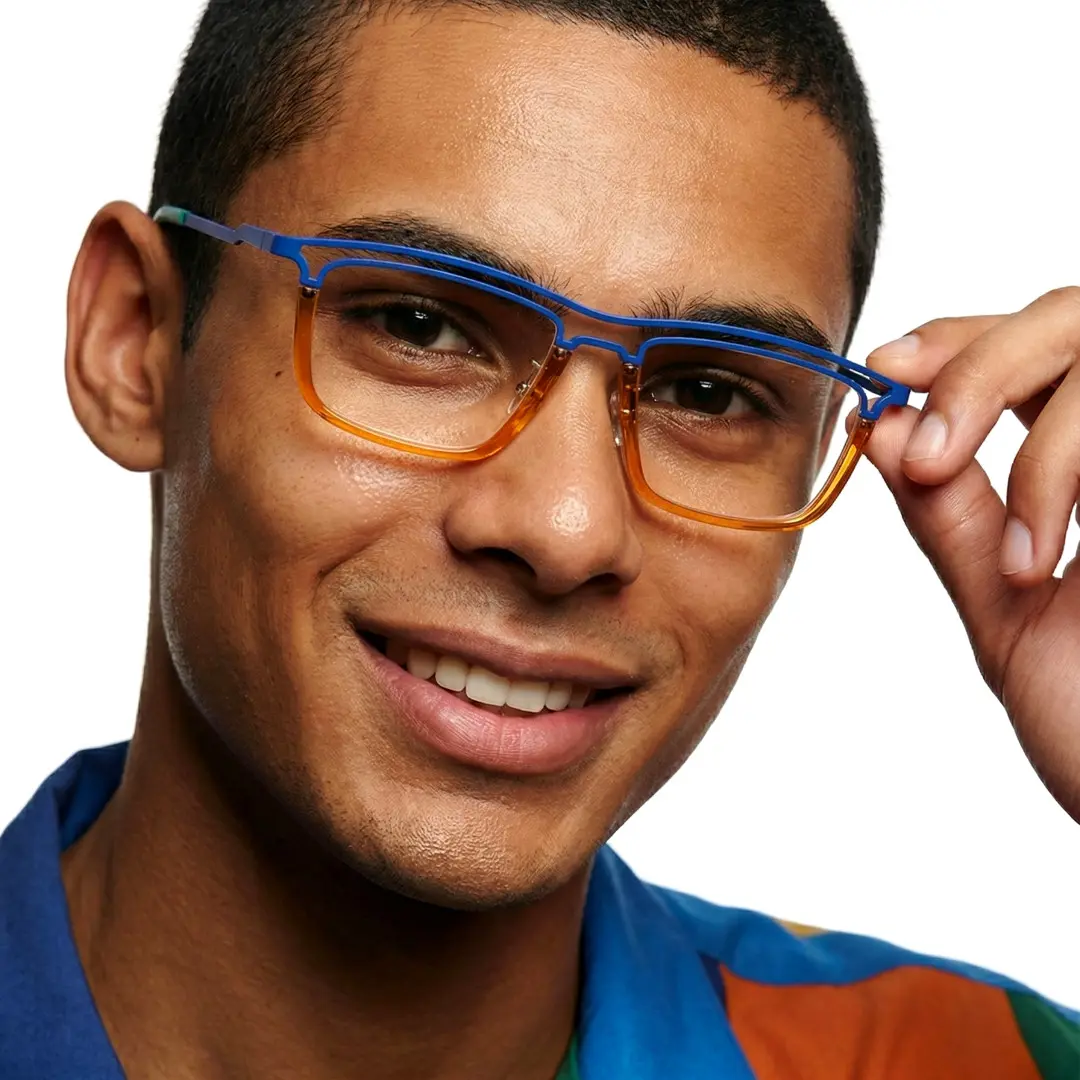 Face close-up view of male wearing orange rectangle eyeglasses, adjusting glasses, smiling, ET0112407
