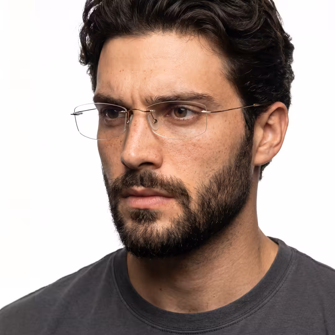 Close-up view of male wearing gold rectangle eyeglasses, neutral expression, ET0242605