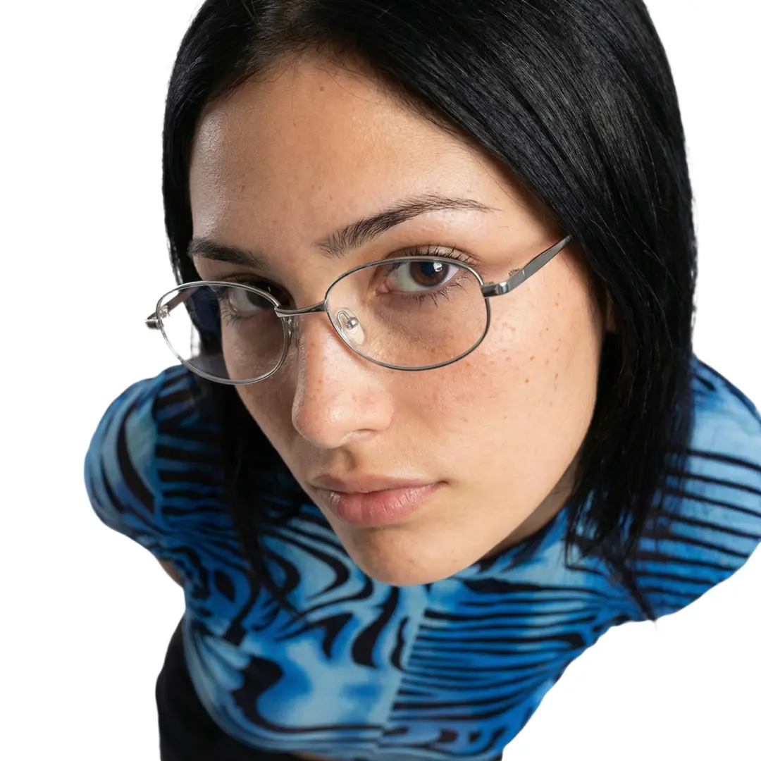 Looking straight ahead view of female wearing silver rectangle eyeglasses, neutral expression, ET0302601