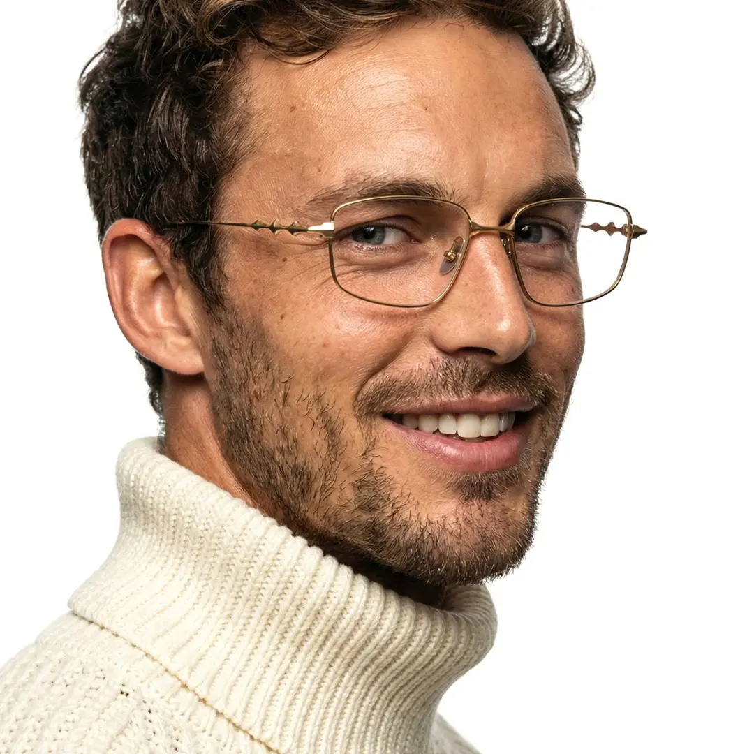 Three-quarter view of male wearing gold rectangle eyeglasses, ET0322501