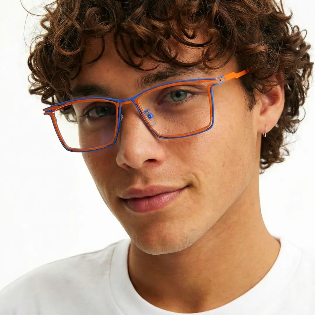 Three-quarter view of male wearing two tone rectangle eyeglasses, relaxed expression, ET0352508