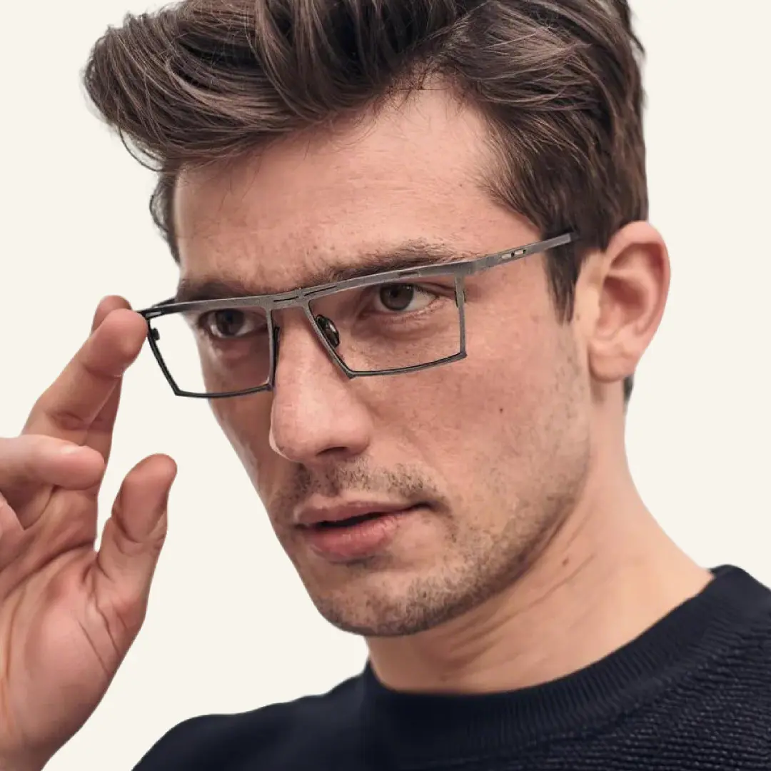 Profile view of male wearing steampunk bronze rectangle eyeglasses, adjusting glasses, relaxed expression, ET0492509