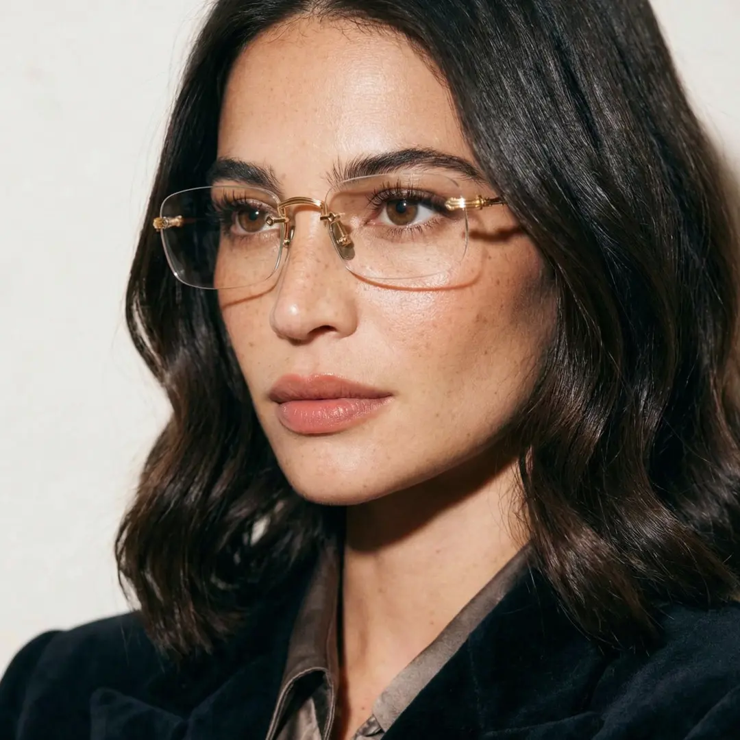 Three-quarter view of female wearing office siren gold rectangle eyeglasses, neutral expression, EM0352412