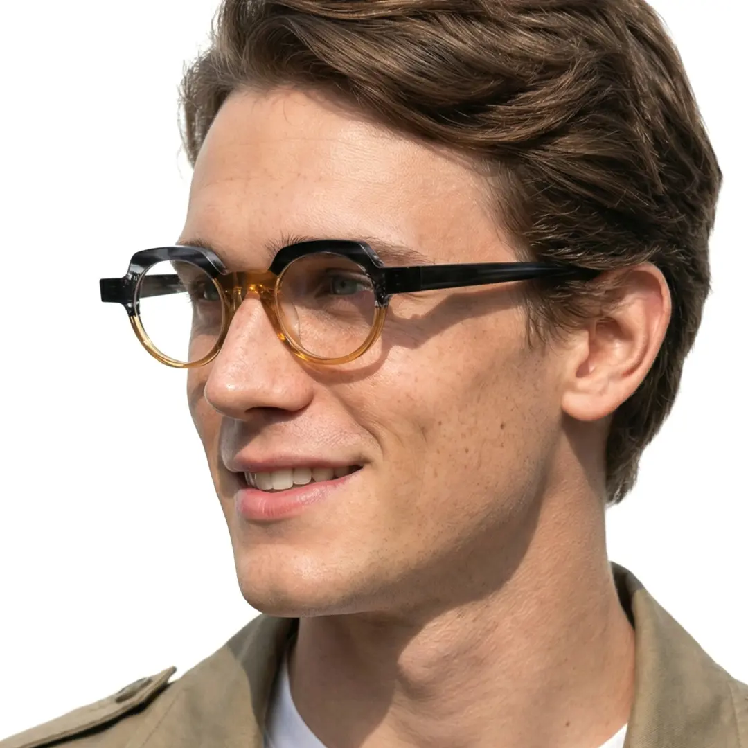 Looking away view of male wearing brown geometric eyeglasses, smiling, GA0032209