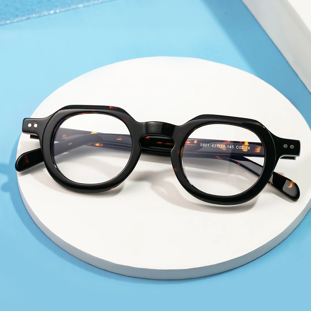Scene close-up view of Edana geometric acetate eyeglasses GA0032301 in tortoise
