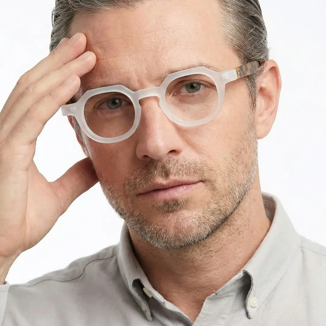 Face close-up view of male wearing vintage white geometric eyeglasses, hand resting on forehead, natural expression, GA0032301