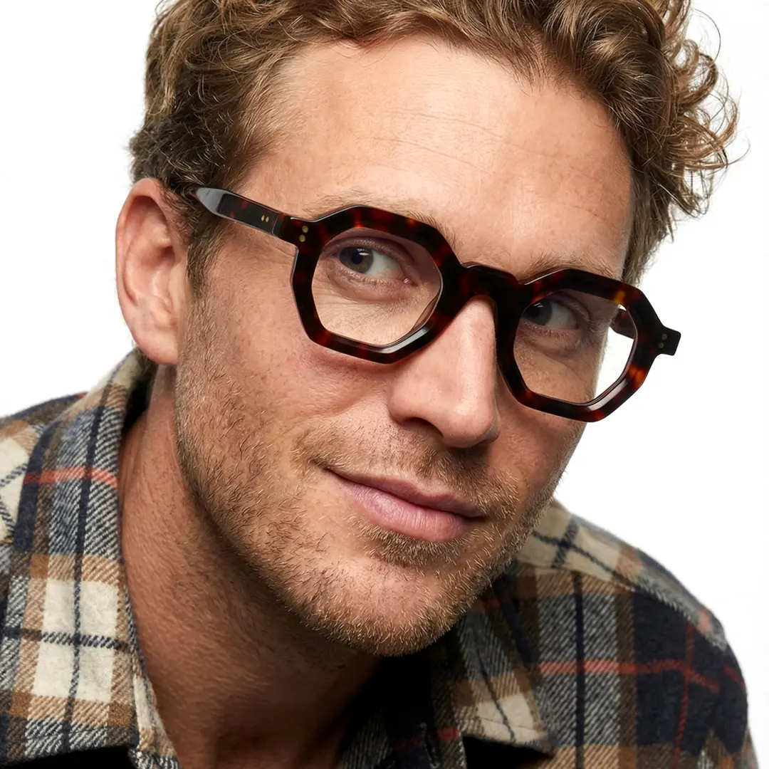 Front view of male wearing tortoise geometric eyeglasses, smiling, GA0052310