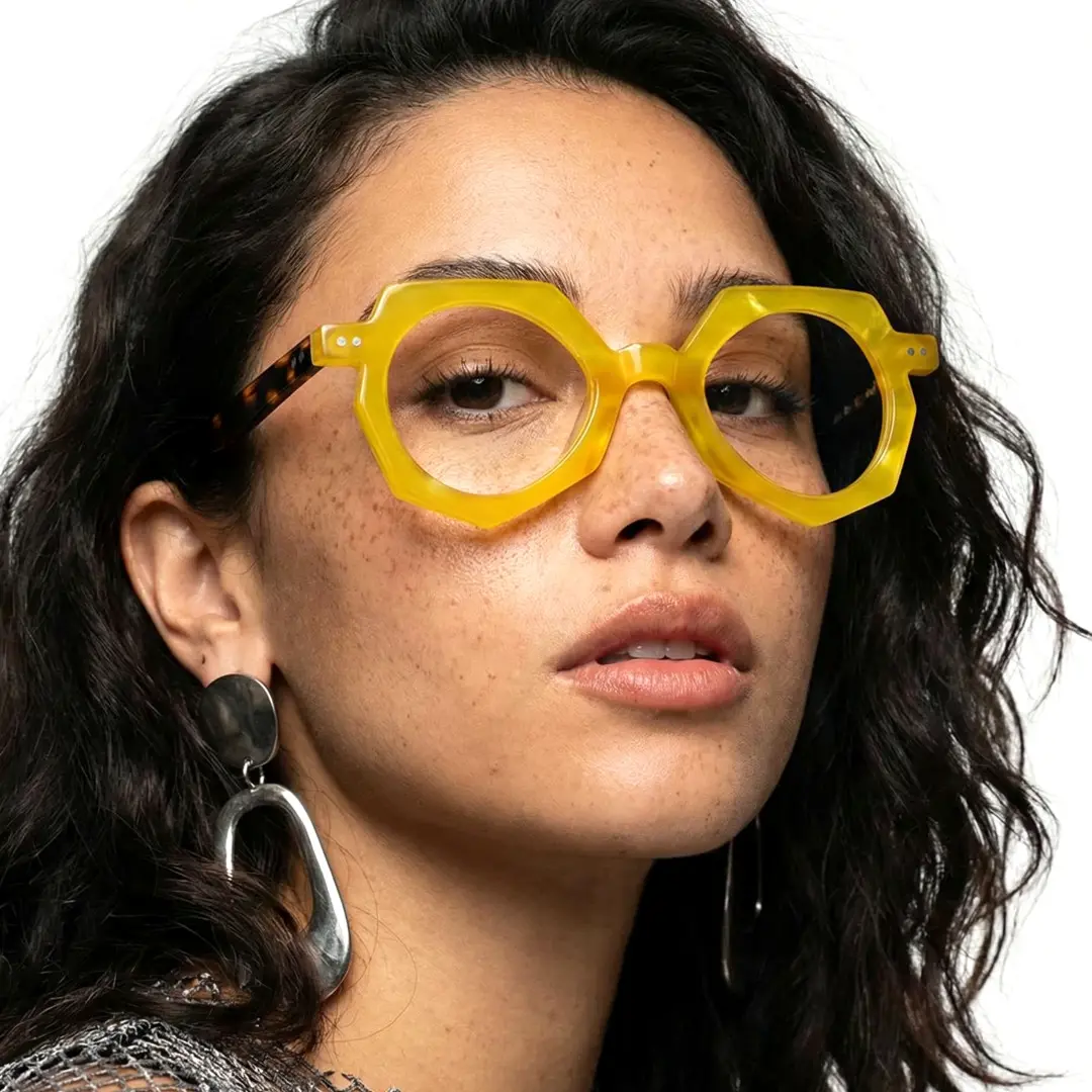 Face close-up view of female wearing vintage yellow geometric eyeglasses, confident expression, GA0062309