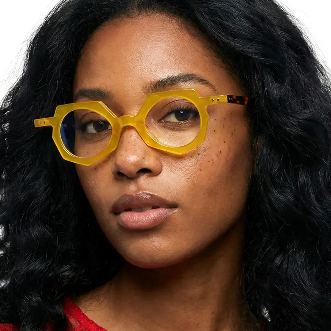 Profile view of female wearing vintage yellow geometric eyeglasses, natural expression, GA0062309