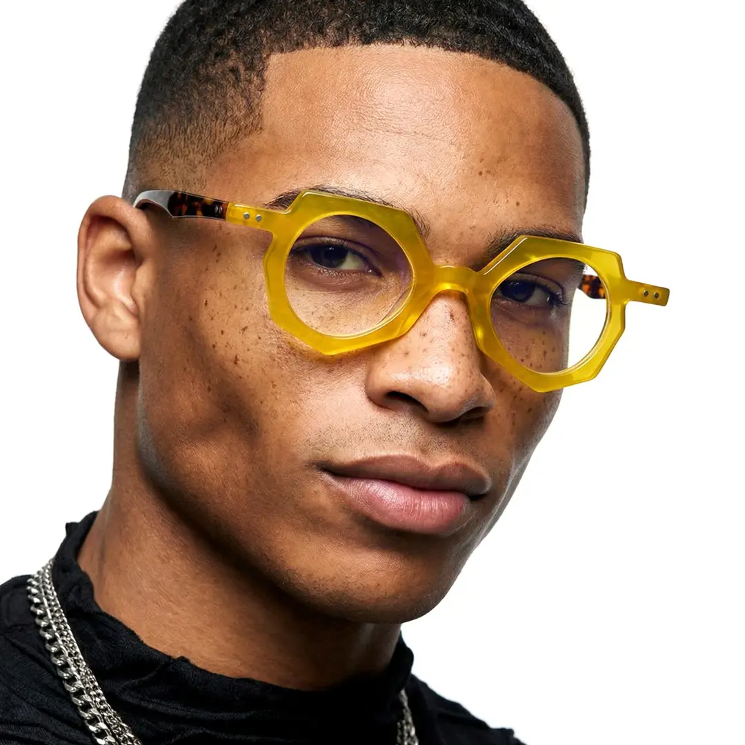 Slightly angled view of male wearing yellow geometric eyeglasses, natural expression, GA0062309