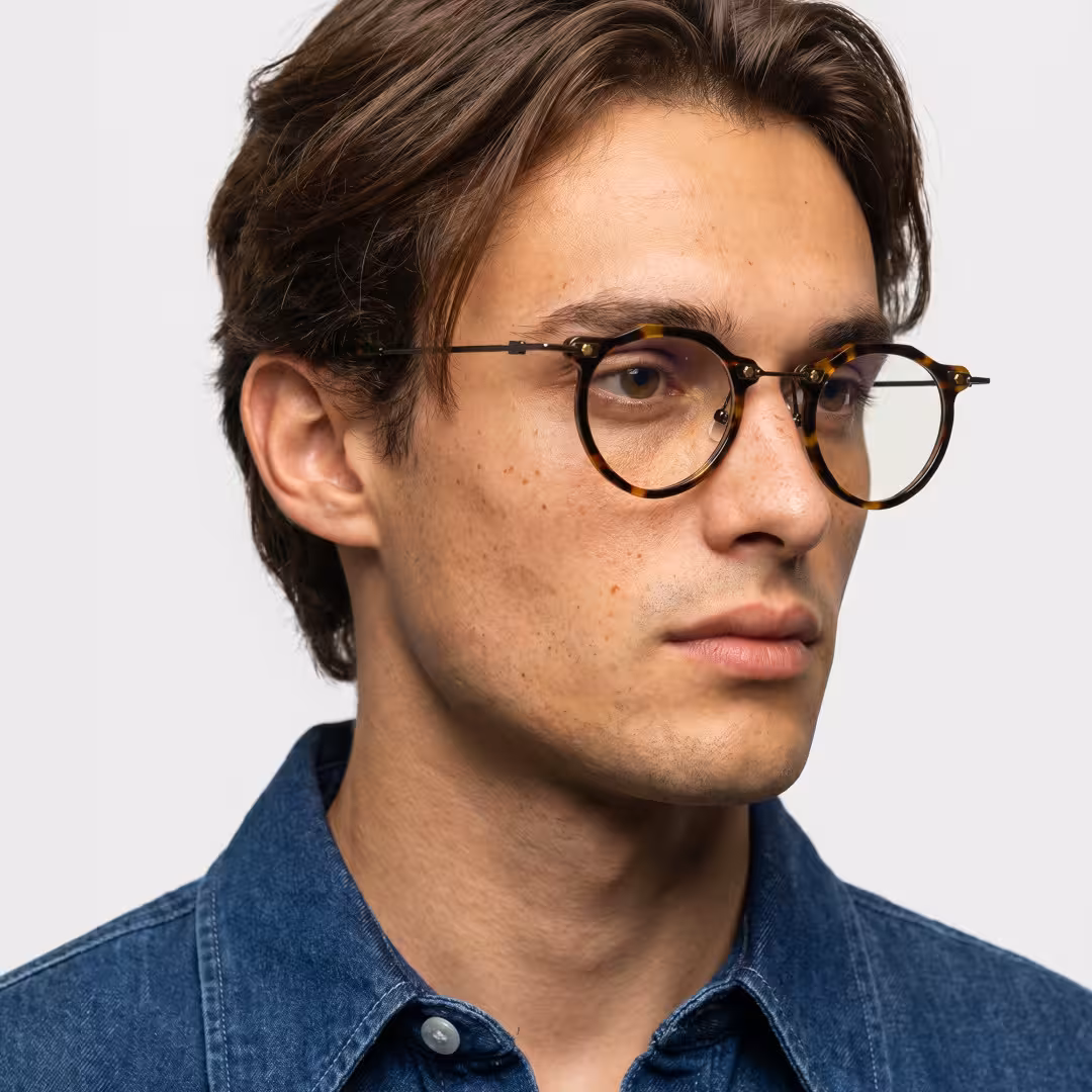 Male wearing steampunk tortoise geometric acetate eyeglasses, neutral expression. SPU: GA0072307