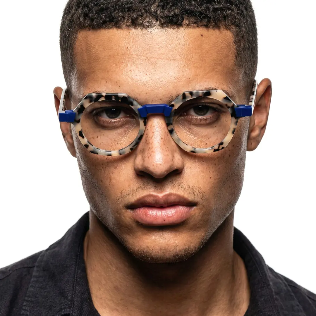 Front view of male wearing vintage tortoise geometric eyeglasses, calm expression, GA0122209