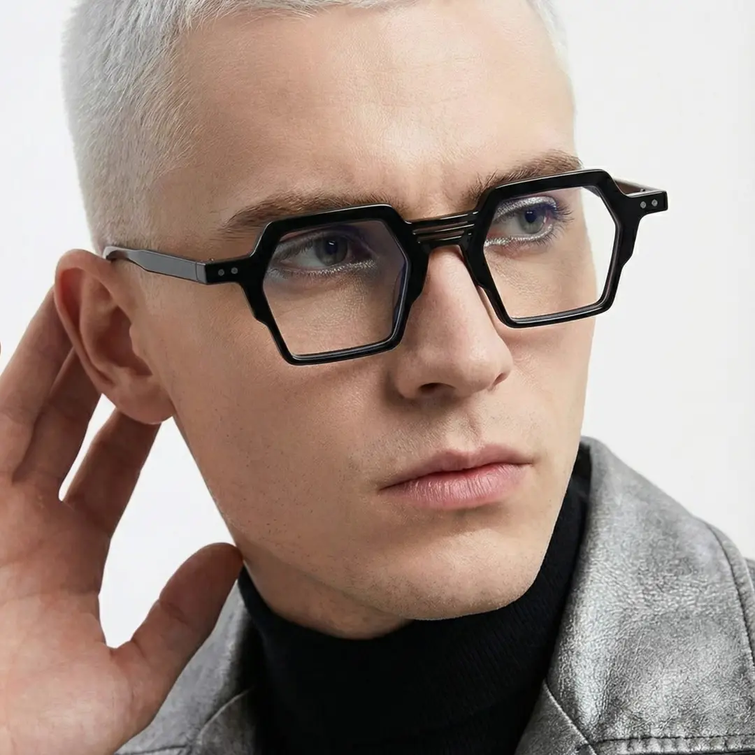 Three-quarter view of male wearing black geometric eyeglasses, tilting head, calm expression, GA0132302
