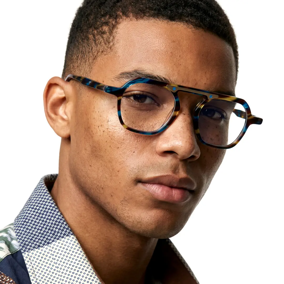 Front view of male wearing blue tortoise geometric eyeglasses, neutral expression, GA0152308