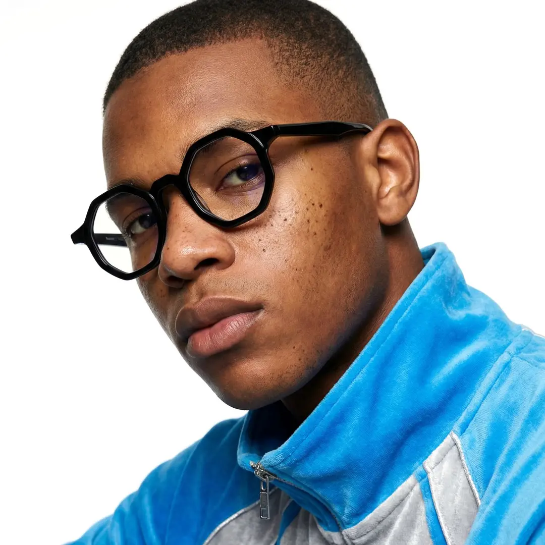 Front view of male wearing black geometric eyeglasses, calm expression, GA0162302