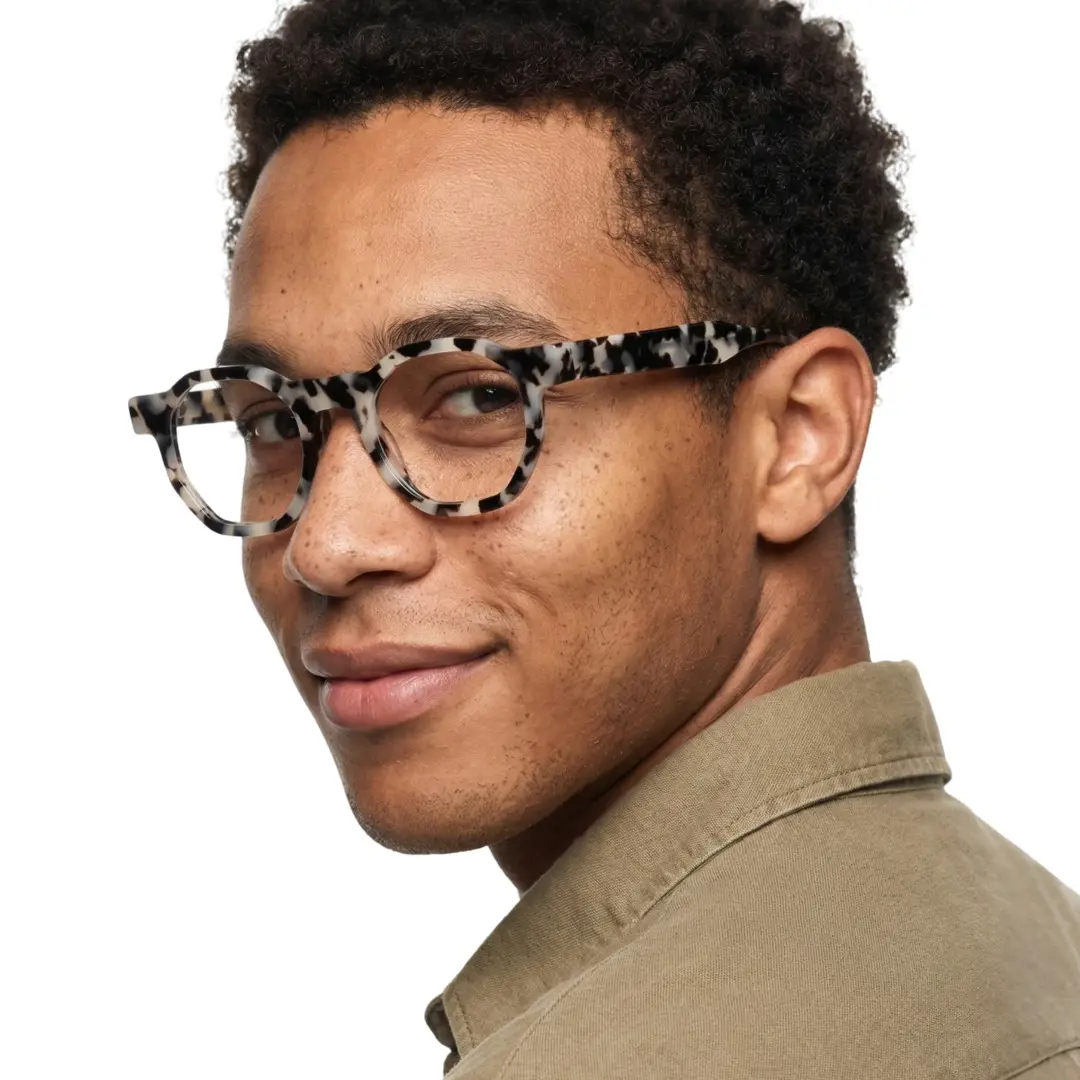 Over-the-shoulder view of male wearing tortoise geometric eyeglasses, natural smile, GA0172406