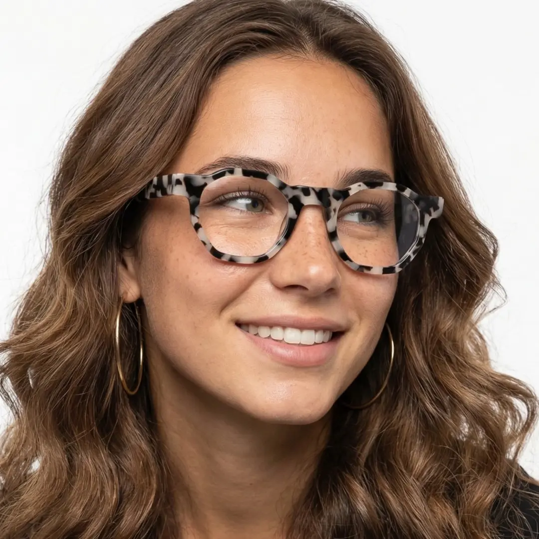 Tilted head view of female wearing tortoise geometric eyeglasses, smiling, GA0172406