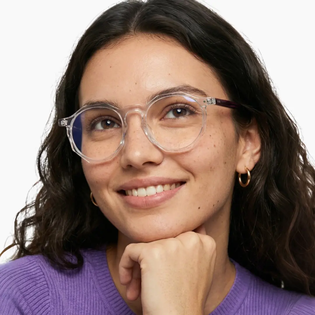 Looking away view of female wearing clear geometric eyeglasses, smiling, GA0212403