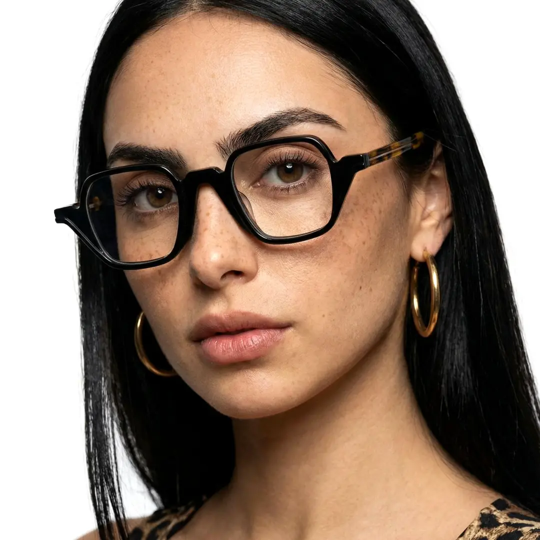 Three-quarter view of female wearing vintage black geometric eyeglasses, neutral expression, GA0242306